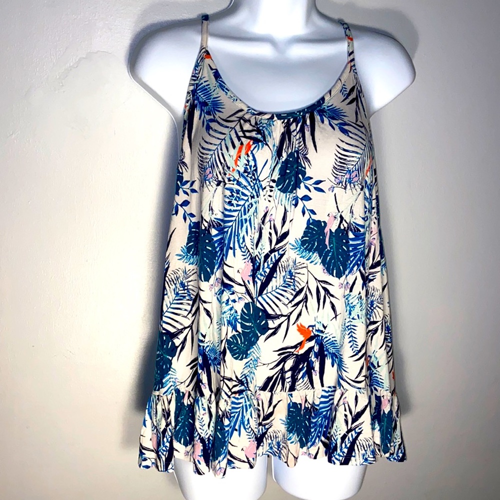 Flared knit tank top with criss cross tie back.